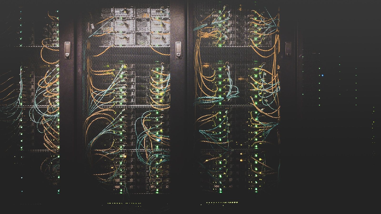 Rows of illuminated server racks in a dark modern data center